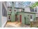 The property features an extensive deck that enhances outdoor living and complements the house's green facade at 1302 Springlawn Ct, Raleigh, NC 27609