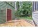 This backyard has an expansive wooden deck surrounded by lush greenery and mature trees in a private setting at 1302 Springlawn Ct, Raleigh, NC 27609
