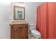 This bathroom features a wood vanity and a toilet with a shower and a mirror above the sink at 1302 Springlawn Ct, Raleigh, NC 27609
