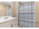 Full bathroom featuring a shower with a colorful curtain and a vanity with a mirror at 1302 Springlawn Ct, Raleigh, NC 27609