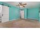 Bright bedroom featuring a ceiling fan, a sliding barn door, and windows at 1302 Springlawn Ct, Raleigh, NC 27609