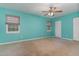 Spacious bedroom with carpet, ceiling fan, and windows offering natural light at 1302 Springlawn Ct, Raleigh, NC 27609