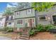 Charming two-story home featuring a red front door and quaint front yard with inviting steps at 1302 Springlawn Ct, Raleigh, NC 27609