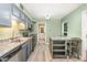Modern kitchen with granite countertops, gray cabinetry, and stainless steel appliances at 1302 Springlawn Ct, Raleigh, NC 27609