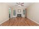 Cozy living room with a fireplace, hardwood floors, ceiling fan and access to the back yard at 1302 Springlawn Ct, Raleigh, NC 27609