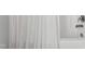 Close-up of a bathtub faucet behind a white shower curtain at 1304 Rodessa Run, Raleigh, NC 27607