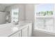 Well-lit bathroom with a white vanity, sleek faucet, and a large mirror at 1304 Rodessa Run, Raleigh, NC 27607