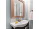 Stylish powder room featuring a pedestal sink and decorative striped wallpaper at 1304 Rodessa Run, Raleigh, NC 27607