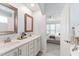 Bathroom with dual sinks and view into the bedroom at 1304 Rodessa Run, Raleigh, NC 27607