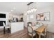 Open dining room featuring contemporary lighting and kitchen access at 1304 Rodessa Run, Raleigh, NC 27607