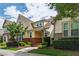 Beautiful exterior view of a two-story home with yellow siding, brick accents, and lush landscaping at 1304 Rodessa Run, Raleigh, NC 27607