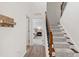 Bright foyer features a staircase with carpet runner and a glimpse of the bedroom at 1304 Rodessa Run, Raleigh, NC 27607