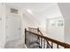 Bright hallway with beautiful hardwood railing, leading to bedrooms at 1304 Rodessa Run, Raleigh, NC 27607