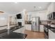 Bright kitchen boasts stainless steel appliances, granite counters, white cabinetry, and a breakfast bar at 1304 Rodessa Run, Raleigh, NC 27607