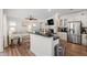 Open concept kitchen with stainless appliances, granite counters, and a view of the living room at 1304 Rodessa Run, Raleigh, NC 27607