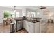 Stylish kitchen featuring stainless steel appliances and an open layout flowing into the living and dining areas at 1304 Rodessa Run, Raleigh, NC 27607