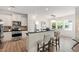 Modern kitchen featuring stainless steel appliances, granite countertops, and an open view to the dining area at 1304 Rodessa Run, Raleigh, NC 27607
