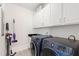 Well-organized laundry room with washer, dryer, and cabinets at 1304 Rodessa Run, Raleigh, NC 27607