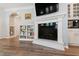 Living room with a fireplace, built-in shelving, and an archway leading to additional living space at 1304 Rodessa Run, Raleigh, NC 27607