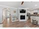 Spacious open-concept living area with hardwood floors, a cozy fireplace, and a view to the kitchen at 1304 Rodessa Run, Raleigh, NC 27607