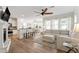 Bright living room featuring a fireplace, hardwood floors, and a seamless transition to the dining area at 1304 Rodessa Run, Raleigh, NC 27607