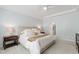 Neutral main bedroom with a ceiling fan, large windows, and ensuite bathroom access at 1304 Rodessa Run, Raleigh, NC 27607