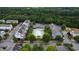 Aerial view features a community pool, trees, and townhomes in a friendly neighborhood at 1304 Rodessa Run, Raleigh, NC 27607