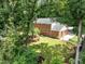 Aerial view of the home with spacious, manicured backyard and surrounding mature trees at 1304 Sandpiper Ct, Raleigh, NC 27615