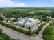 Commercial building in a park-like setting, with parking, landscaping, and a tree-lined horizon at 1304 Sandpiper Ct, Raleigh, NC 27615