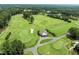 An aerial view of a pristine golf course with lush greenery and manicured greens at 1304 Sandpiper Ct, Raleigh, NC 27615