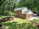 Aerial view of the brick home showcasing the wooden deck and green backyard at 1304 Sandpiper Ct, Raleigh, NC 27615