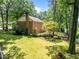 Back exterior view with a wooden deck and a well-maintained grassy yard at 1304 Sandpiper Ct, Raleigh, NC 27615