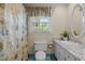 Bathroom featuring a vanity, toilet, a large window, and a shower with curtain at 1304 Sandpiper Ct, Raleigh, NC 27615