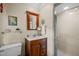 Well-lit bathroom featuring a vanity with storage, a sink, and a glass-enclosed shower at 1304 Sandpiper Ct, Raleigh, NC 27615