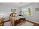 Bright bedroom features hardwood floors, white walls, and a large window for natural light at 1304 Sandpiper Ct, Raleigh, NC 27615