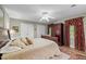 Comfortable bedroom featuring a large bed, wardrobe, ceiling fan, and natural light at 1304 Sandpiper Ct, Raleigh, NC 27615