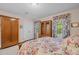 This bedroom includes floral accents, wood furniture, and ample storage space at 1304 Sandpiper Ct, Raleigh, NC 27615