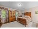 Comfortable bedroom boasts a patterned rug, wooden furniture, and floral curtains, creating a cozy atmosphere at 1304 Sandpiper Ct, Raleigh, NC 27615