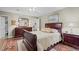 Spacious bedroom with hardwood floors, large bed, dresser, and ample natural light at 1304 Sandpiper Ct, Raleigh, NC 27615