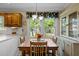 Cozy dining area with wooden table set, chandelier, and a bright window view at 1304 Sandpiper Ct, Raleigh, NC 27615