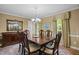 Formal dining room with elegant furniture, chandelier, and large windows at 1304 Sandpiper Ct, Raleigh, NC 27615