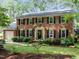Charming two-story brick home with black shutters and a well-manicured front yard at 1304 Sandpiper Ct, Raleigh, NC 27615