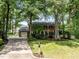 Two-story brick home with lush landscaping, driveway, and mature trees at 1304 Sandpiper Ct, Raleigh, NC 27615