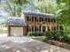 Traditional brick home with attached garage, long driveway, and manicured landscaping at 1304 Sandpiper Ct, Raleigh, NC 27615