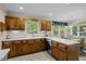 Spacious kitchen with wooden cabinets, stainless steel appliances, and dining area at 1304 Sandpiper Ct, Raleigh, NC 27615