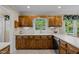 Classic kitchen with wood cabinets, stainless steel appliances, and a bright window above the sink at 1304 Sandpiper Ct, Raleigh, NC 27615