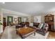 Open-concept living area with hardwood floors, large windows, and comfortable seating arrangements at 1304 Sandpiper Ct, Raleigh, NC 27615