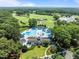 Aerial view of a large community pool surrounded by trees and a golf course at 1304 Sandpiper Ct, Raleigh, NC 27615