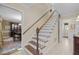 Classic staircase with wooden treads, white risers, and elegant trim at 1304 Sandpiper Ct, Raleigh, NC 27615