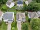 Aerial view of a home with a well-manicured yard and mature trees in a quiet neighborhood at 132 Ryder Cup Cir, Raleigh, NC 27603